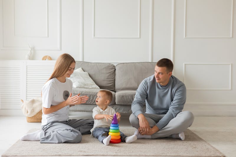 a couple with a small kid in the living room